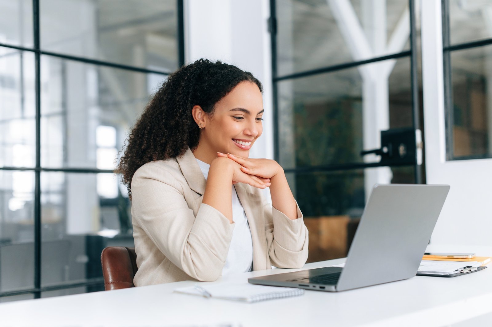 Pretty brazilian or hispanic curly haired business lady in elegant clothes, ceo, team leader, hr